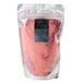 A bag of pink powder with blue and red sugar in it.