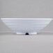 A white Milano melamine bowl with a white rim on a gray surface.