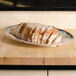 A platter of sliced bread on a wooden surface.