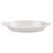 An ivory oval side dish with a handle.