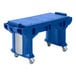 A blue plastic Cambro Versa work table with wheels.