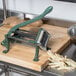 A Choice Prep French Fry Cutter on a cutting board with potatoes.