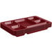 A stack of red Cambro heavy-duty polycarbonate compartment trays on a counter.