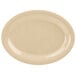 A beige oval platter with speckled edges on a white surface.