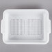 A white plastic Vollrath perforated drain box.