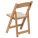 A wooden folding chair with a white cushion.