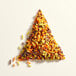 A triangle made of Adourne Autumn Sprinkles on a white surface.