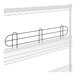 A wire shelf with black metal railings on it.