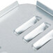 A close up of a metal back cover plate with four holes.