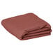 A folded mauve rectangular cloth table cover.