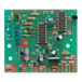 A green circuit board with many electronic components.
