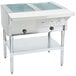 A stainless steel Eagle Group liquid propane steam table open well with two pans inside.