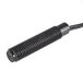 A black metal object with a black wire and a long tube.