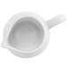 A white porcelain creamer with a handle.