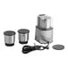A commercial spice grinder with a stainless steel base, three metal grinding bowls with lids, and a power cord.
