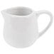 A white porcelain creamer pitcher with a handle.