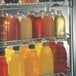 A Metro qwikSLOT wire shelf holding many types of drinks.