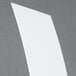 A white rectangular splash guard on a gray surface.