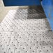 A blue rectangular Spilfyter heavy weight absorbent pad with a white strip and holes in it.