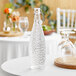 A clear glass Libbey water bottle on a table.