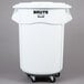 A white plastic Rubbermaid BRUTE trash can on wheels.