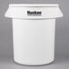 A white Continental Huskee 20 gallon trash can with lid and dolly.