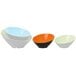 A group of GET Brasilia melamine bowls in orange, black, and white on a white background.