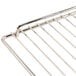 A close up of a stainless steel wire rack with a handle.