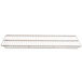 A metal rack on a stainless steel shelf.