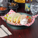 A plate of tacos with jalapeno deli servers and salsa.