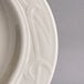 A close-up of a Homer Laughlin ivory china platter with a design on the edge.