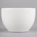 A Homer Laughlin bright white china bouillon bowl with a white rim on a grey surface.