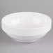 A Homer Laughlin bright white bowl with a white rim on a gray surface.