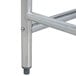 A stainless steel work table with an open metal base.