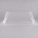 A clear plastic sneeze guard with a lid for an Avantco hot dog roller grill.