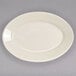 A white oval Homer Laughlin china platter with a rolled edge on a gray surface.