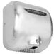 A stainless steel XLERATOR hand dryer with a black label.