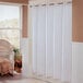 A white Hookless shower curtain hanging in a bathroom.