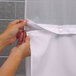 A person snapping white It's A Snap! shower curtain liner magnets together.