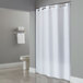 A white Hookless shower curtain hanging in a bathroom.