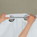 A person hanging a Hookless white shower curtain.