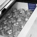 A drawer full of glass cups inside a Turbo Air glass froster on a counter.