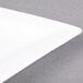 A CAC white porcelain dinner plate with a white rim.