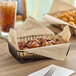 A basket of croissants and donuts lined with a piece of natural kraft paper.