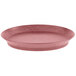 An oval raspberry polypropylene deli server with a short base on a table.