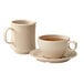 Two cups of coffee on a saucer.