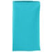 A folded teal cloth napkin on a white background.