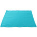 A teal polycotton cloth napkin on a white surface.