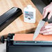 A person using a Victorinox Multi-Oilstone to sharpen a knife.