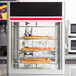 A Hatco pizza rack with pizzas in a pizza display case.